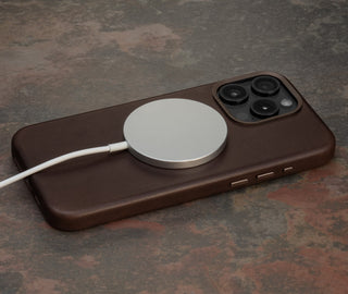 MagSafe charger attached to the Dark Brown Slimline Leather Bumper Case for iPhone 15 Pro Max