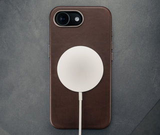 MagSafe charger attached to the Dark Brown Slimline Leather Bumper Case for iPhone SE4 (2025)