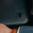 Close up of the leather grain and TORRO bulls head logo on the front of the Black Leather Laptop Sleeve for 15” and 16” Apple MacBook