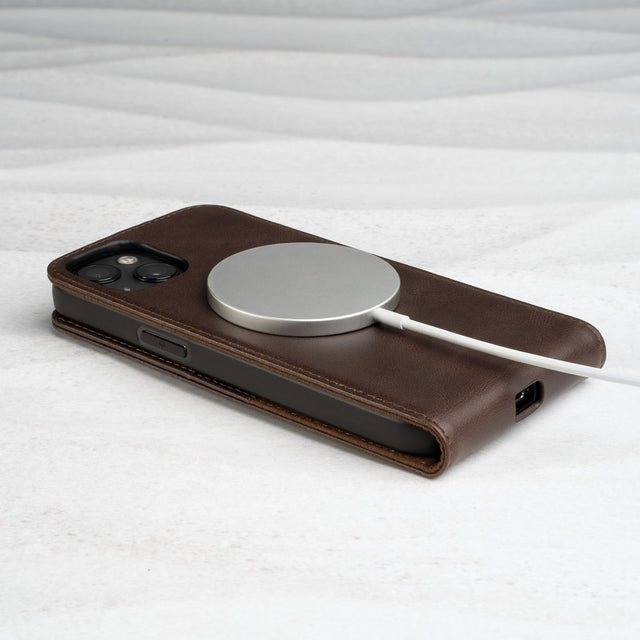 MagSafe charger attached to the Dark Brown Leather Flip Case for iPhone 14 Plus