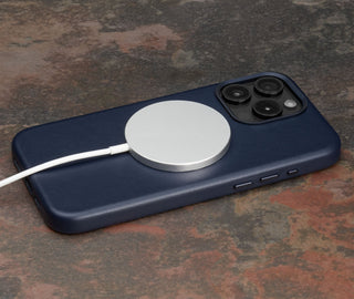 MagSafe charger attached to the Navy Blue Slimline Leather Bumper Case for iPhone 15 Pro Max