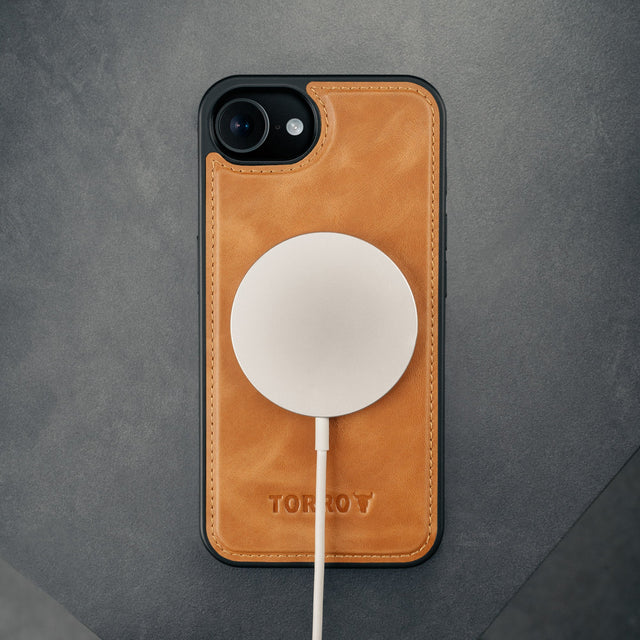 MagSafe charger attached to the Bumper case section of the Black Leather Detachable Case for iPhone SE4