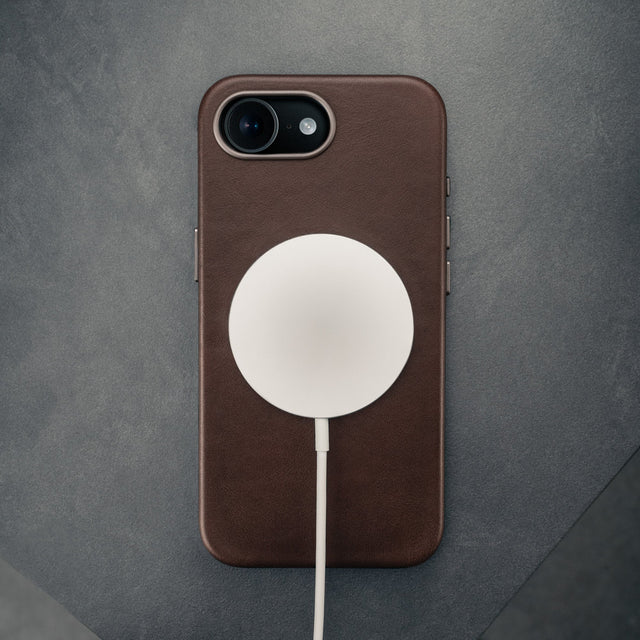MagSafe charger attached to the Dark Brown Slimline Leather Bumper Case for iPhone SE4 (2025)